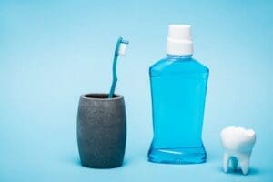Toothbrush, tooth model and bottle of mouthwash