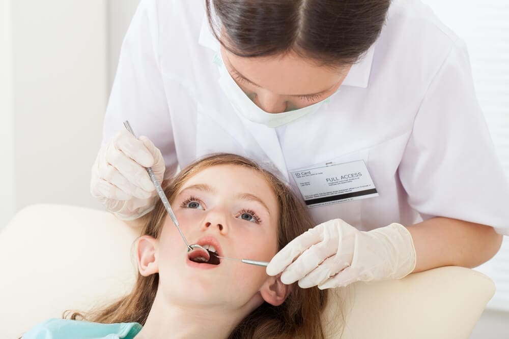 Dentist examining girl mouth